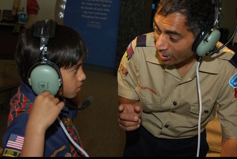 ARISS Worker teaches student with headset on